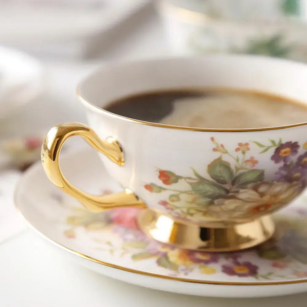 A delicate white porcelain tea cup set with gold trim and floral pattern from decorbites™ bone china collection