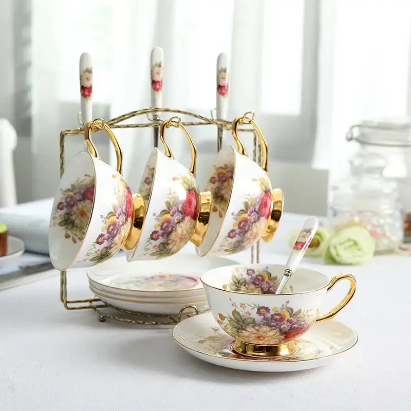 A delicate white porcelain tea cup set with gold trim and vibrant floral pattern displayed on matching saucer