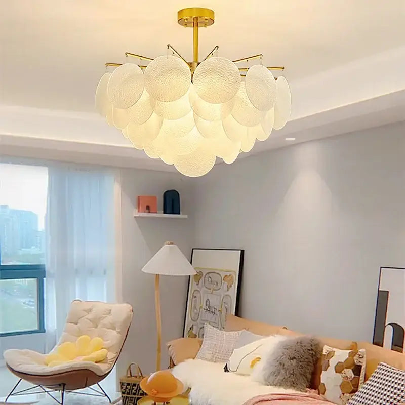 Gold-toned decorbites elegant glass chandelier with textured white circular shades ideal for bedroom lighting