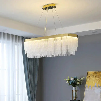 Gold-framed rectangular crystal chandelier with cascading clear strands featuring modern gold luster for home lighting