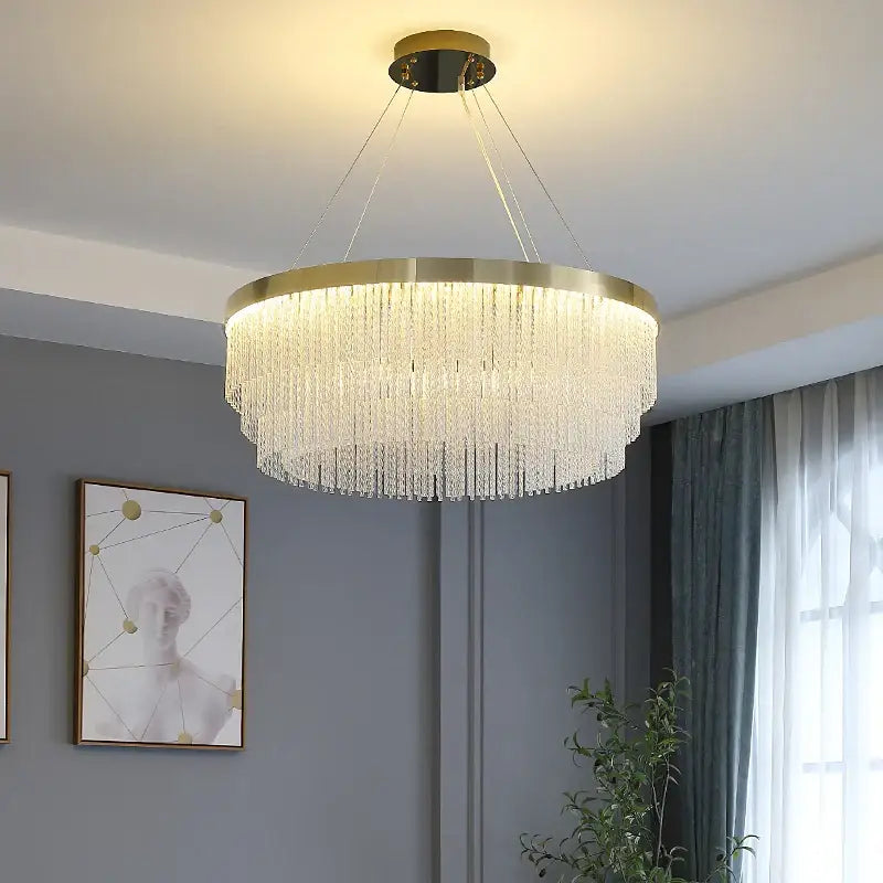 Modern gold luster crystal chandelier with gold-toned metal frame and cascading clear crystal beads for home lighting