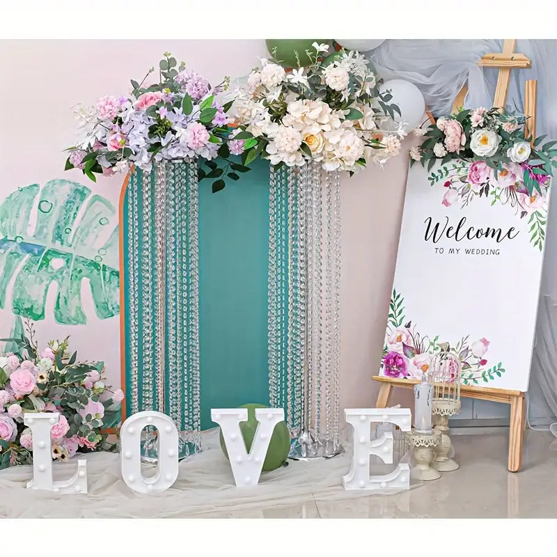 Teal and silver beaded wedding backdrop with floral arrangements featuring decorbites elegant metal vases for wedding decor