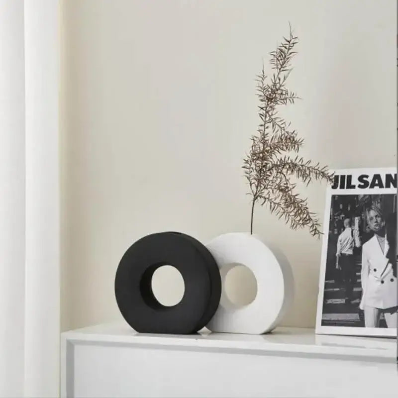 Black and white ceramic donut vase decorative objects on shelf for elegant nordic home decor and flower vase use