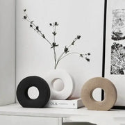 Three minimalist donut vases in black white and beige ceramic for elegant home decor and flower vase display