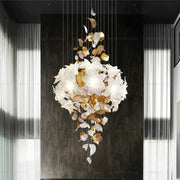 Elegant white and gold leaf chandelier with cascading sculptural design from decorbites elegant villa for living room light