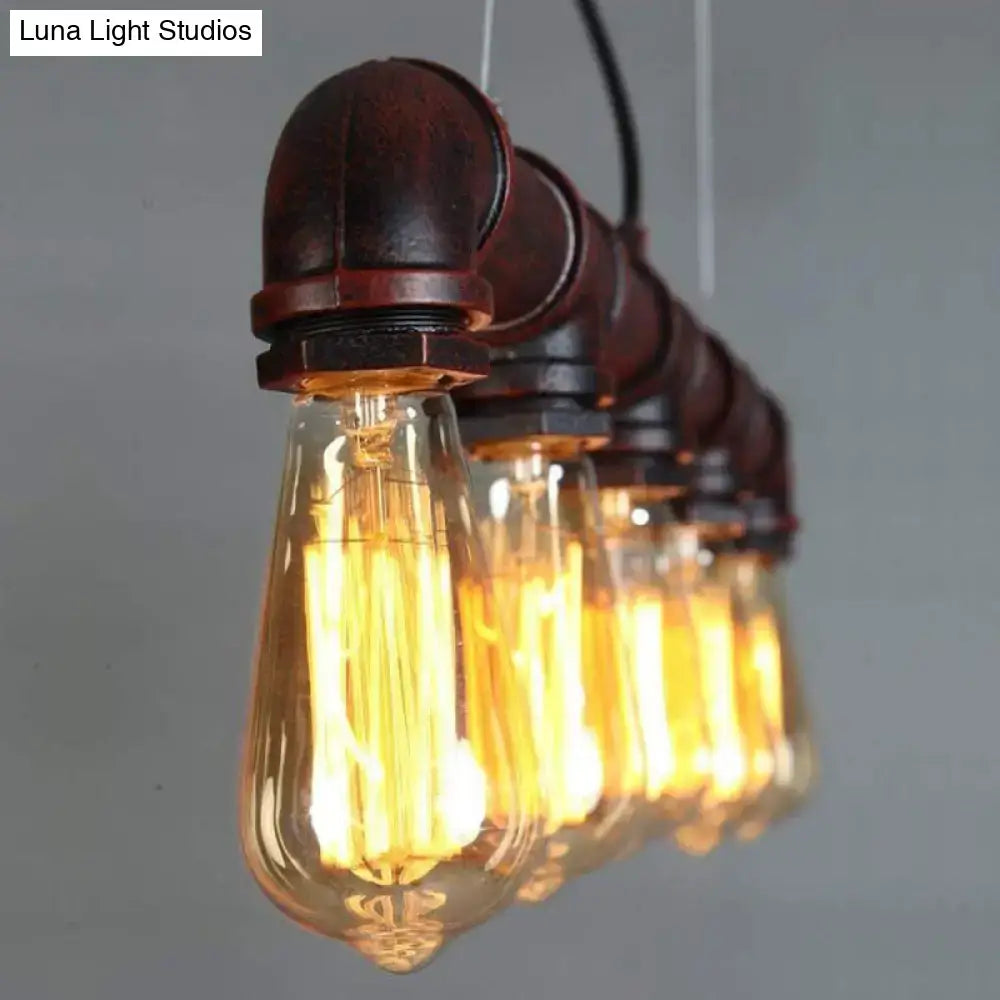 Industrial-style elongated pipe island pendant light with amber filament bulbs and rustic metal pipe fittings for dining room
