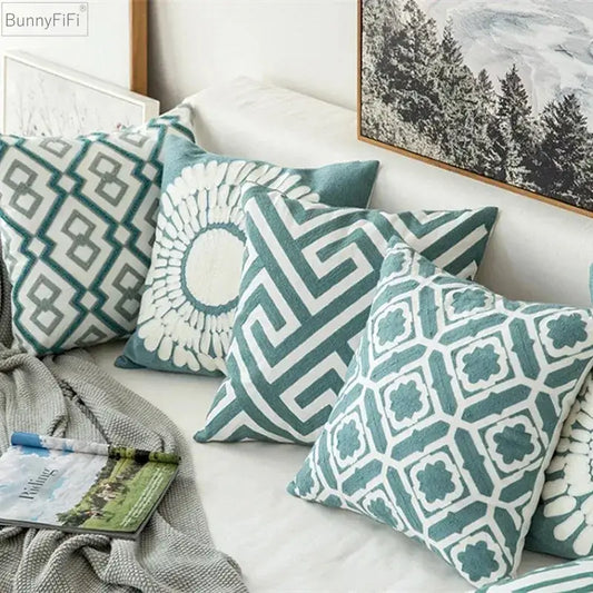 Set of five teal and white decorbites embroidered blue cotton cushion covers with geometric patterns for living room