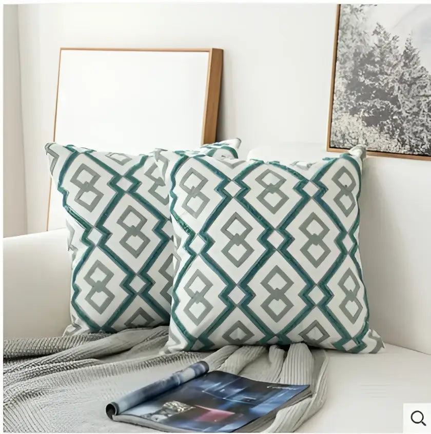 Two square green and gray geometric patterned throw pillows featuring decorbites embroidered blue cotton cushion cover design
