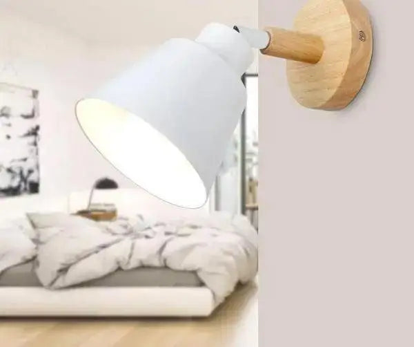White metal eryka wall sconce with wooden base and arm featuring a sleek conical shade for modern nordic decor