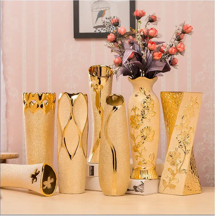A collection of elegant gold-plated ceramic vases with intricate floral and geometric designs for home decor