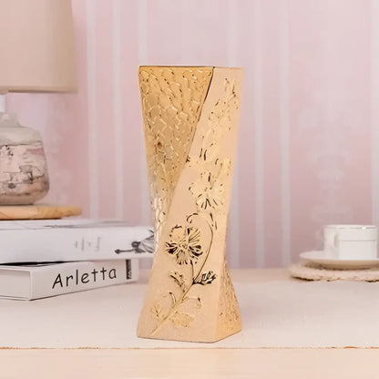 DecorBites Europe gold-plated ceramic vase with intricate floral carvings and tapered twisted design for home decor