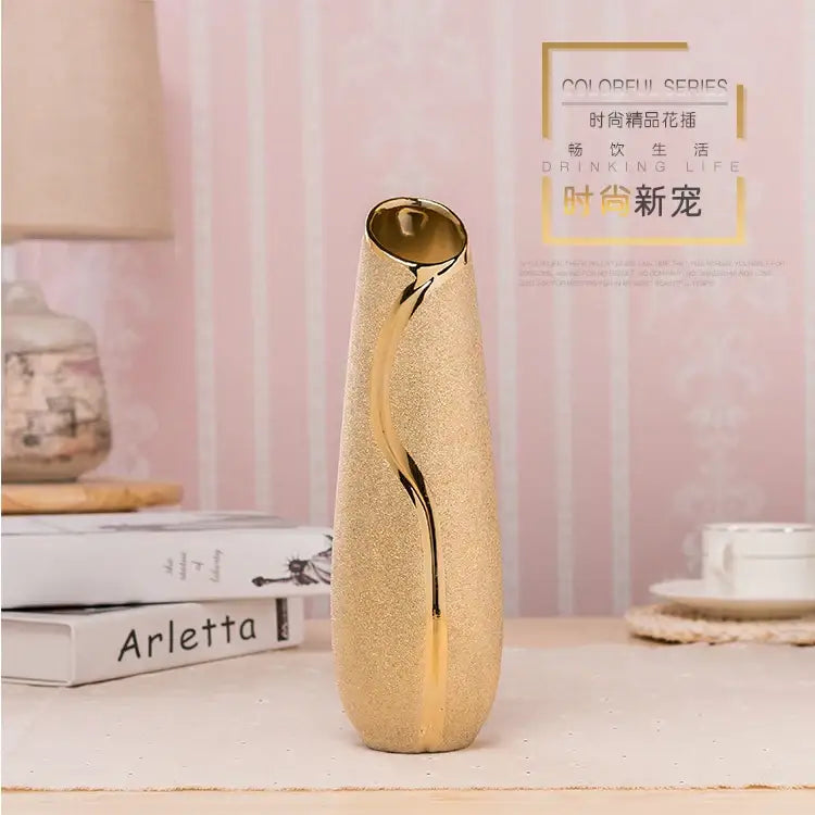 A sleek gold-plated ceramic vase with textured surface and elegant curves for home decor by decorbites europe