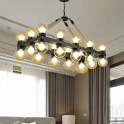 DecorBites™ farmhouse black pendant light with black metal frame, braided rope, and 24 cognac glass bulbs for dining room
