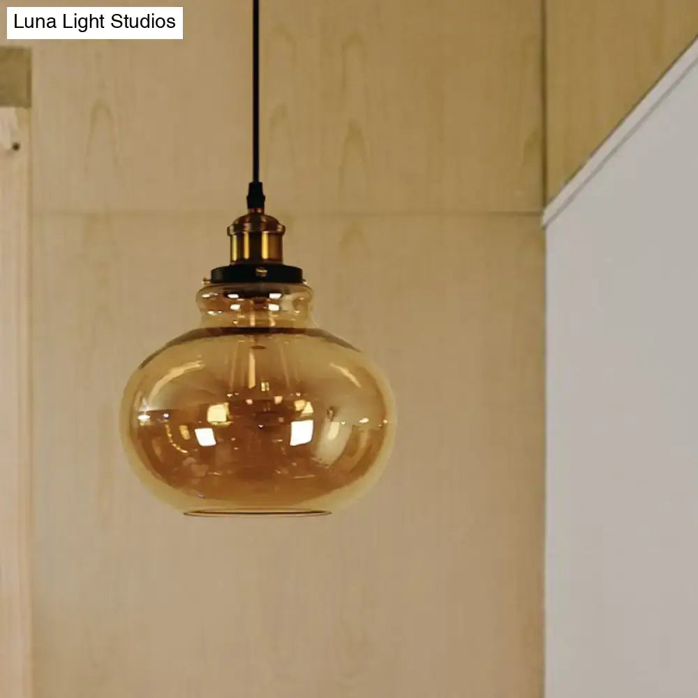 Decorbites farmhouse brass pendant ceiling light with amber glass globe and black cord for indoor use