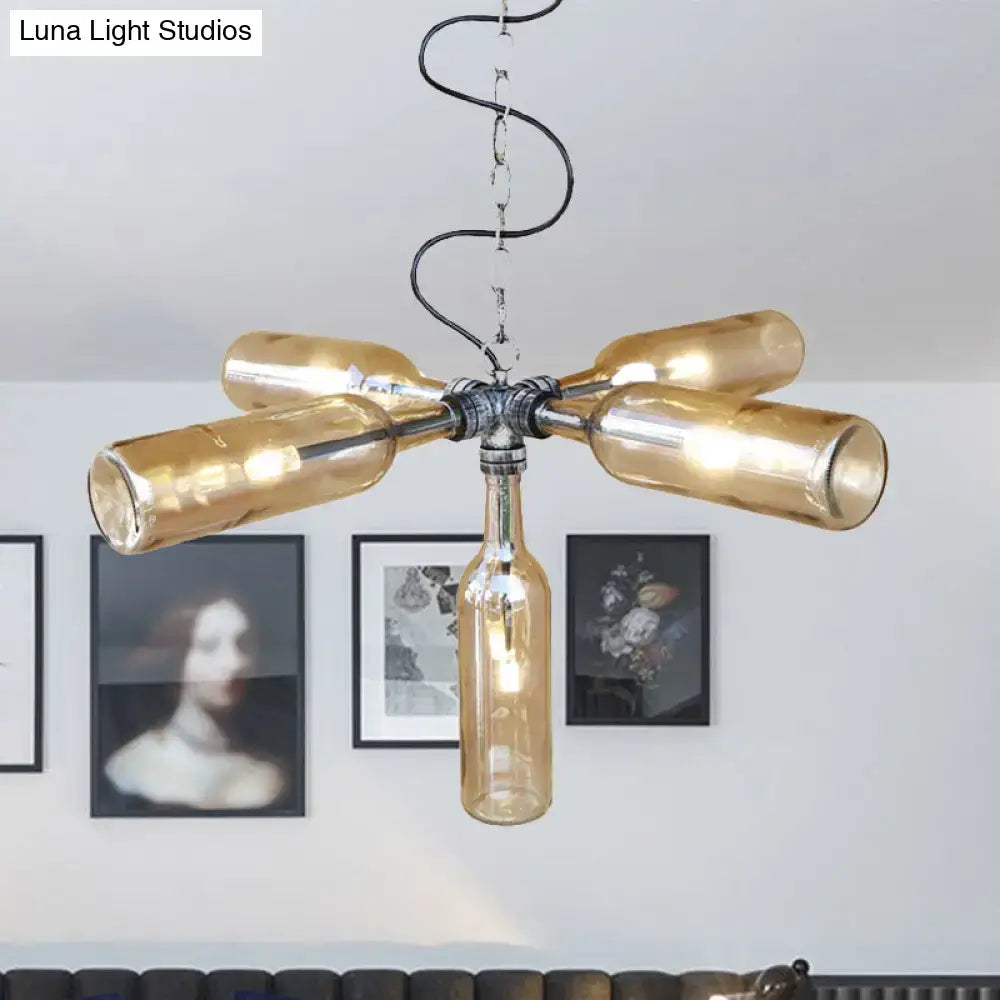A rustic farmhouse chandelier with amber glass bottles in aged silver black finish and smoke gray blue accents