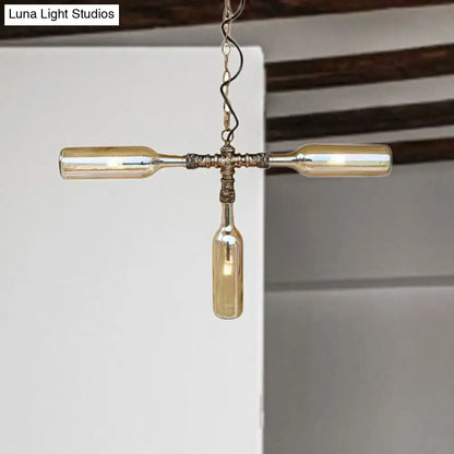 A rustic farmhouse style chandelier with three amber glass bottles hanging from an aged silver black twisted chain