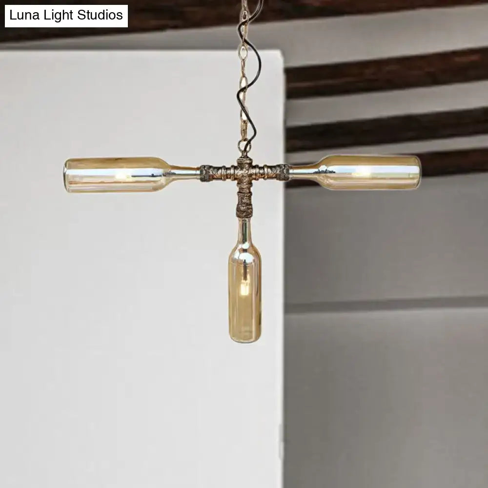 A rustic farmhouse style smoke gray blue bottle chandelier with aged silver black finish and three repurposed amber glass bottles
