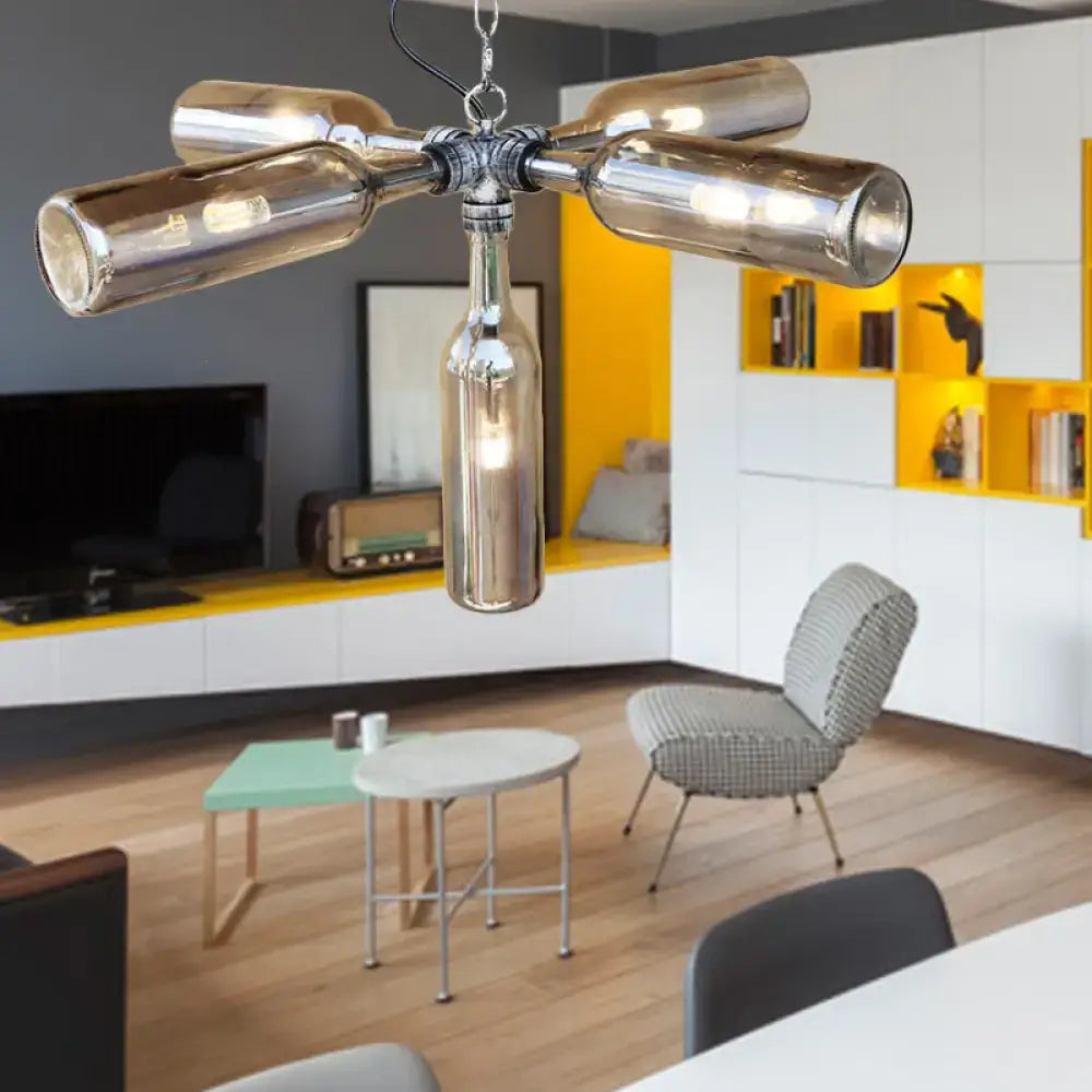 A modern decorbites farmhouse style chandelier with recycled smoke gray blue glass bottles in aged silver black finish