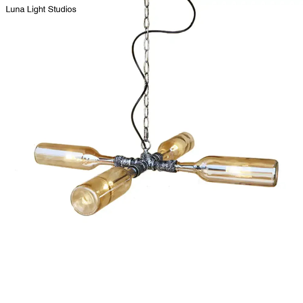 Industrial pendant light with four amber glass bottles on aged silver black metal hub in smoke gray blue farmhouse style
