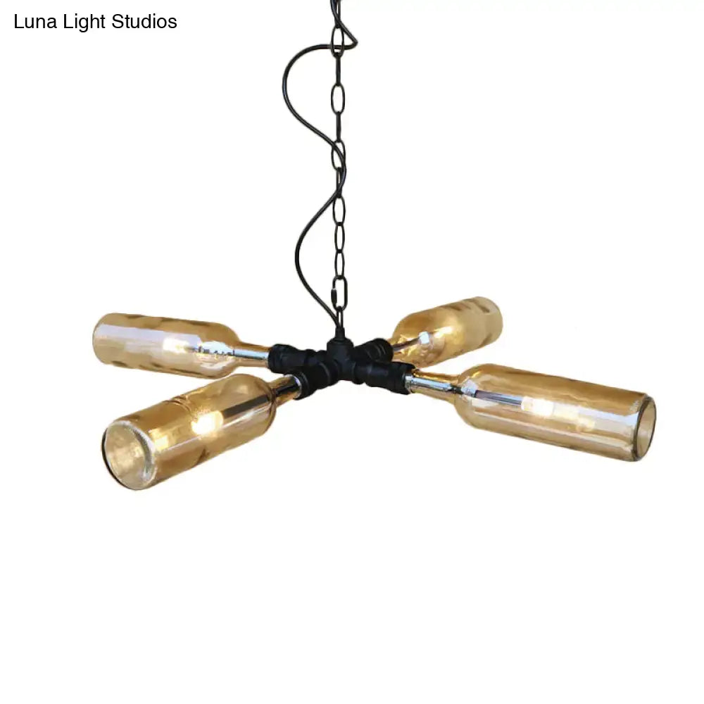 A rustic chandelier with four amber glass bottles on aged silver black metal frame in smoke gray blue farmhouse style