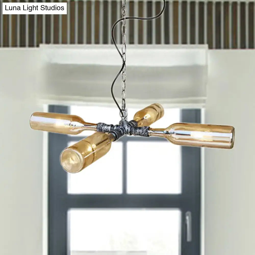 Industrial-style chandelier with four amber glass bottles in smoke gray blue and aged silver black metal fixture