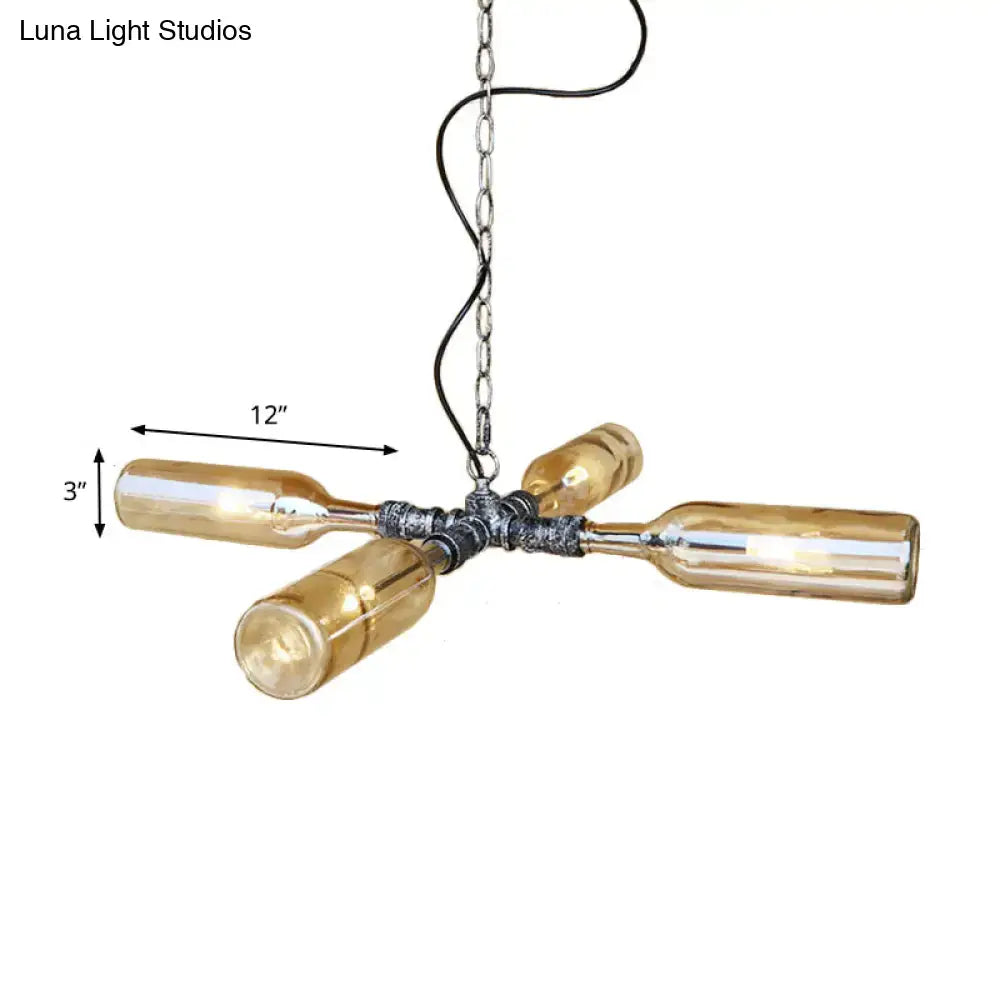 Industrial pendant light with four amber glass wine bottles in cross pattern featuring aged silver black metal fittings