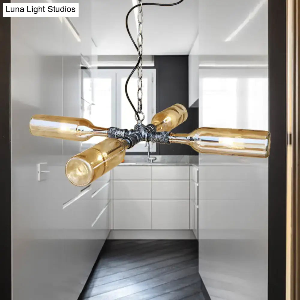 Industrial chandelier with four amber glass wine bottles in aged silver black and smoke gray blue finish by DecorBites