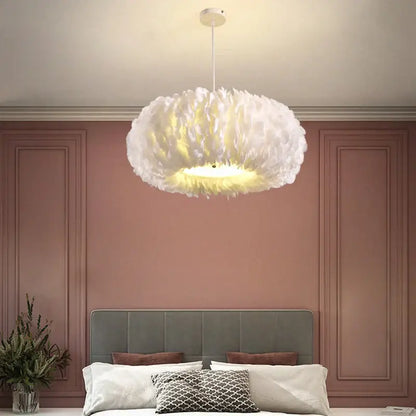 White soft feather decor led chandelier by decorbites with warm glow hanging above bedroom pendant light