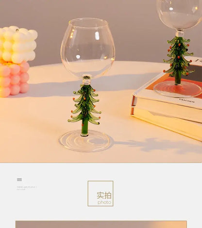 Clear glass wine goblet with green tree-shaped stem and orange ornaments from DecorBites™ christmas wine glasses