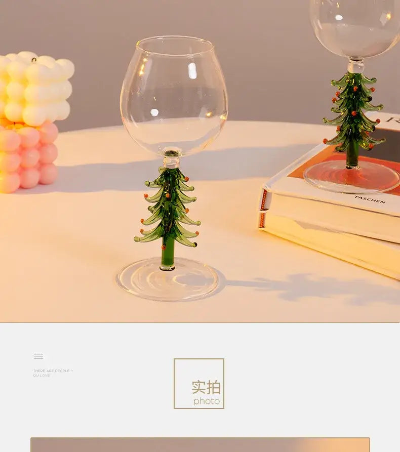 Clear glass wine goblet with green tree-shaped stem and orange ornaments from DecorBites™ christmas wine glasses