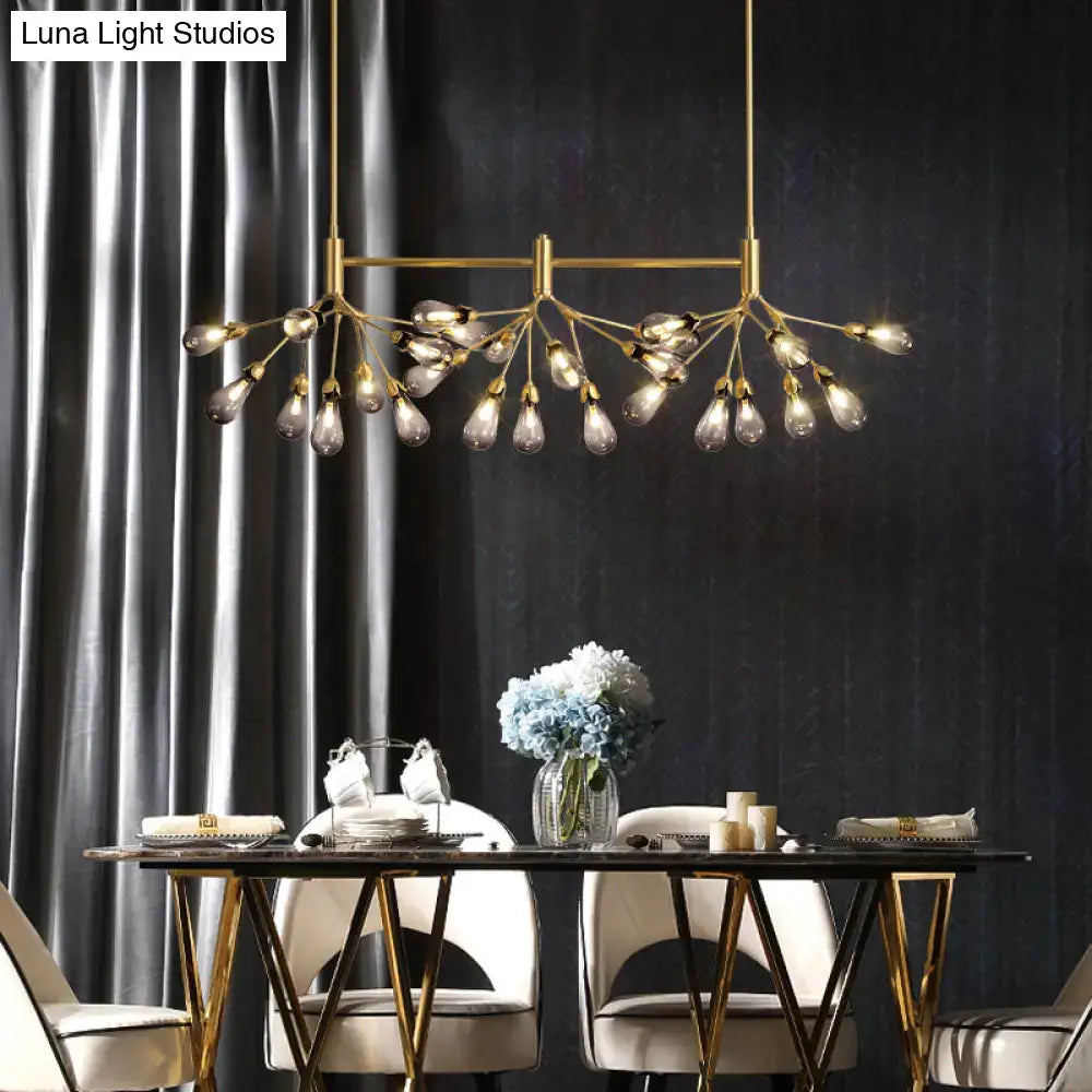 Gold-toned brass finish DecorBites™ firefly suspension light with multiple exposed glass bulbs in a modern design