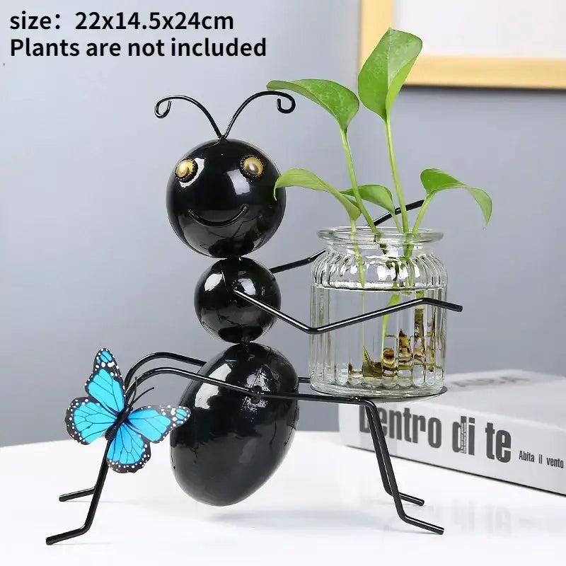 Black metal ant figurine with gold eyes and blue butterfly holding a glass jar for home decor flamingo metal vase