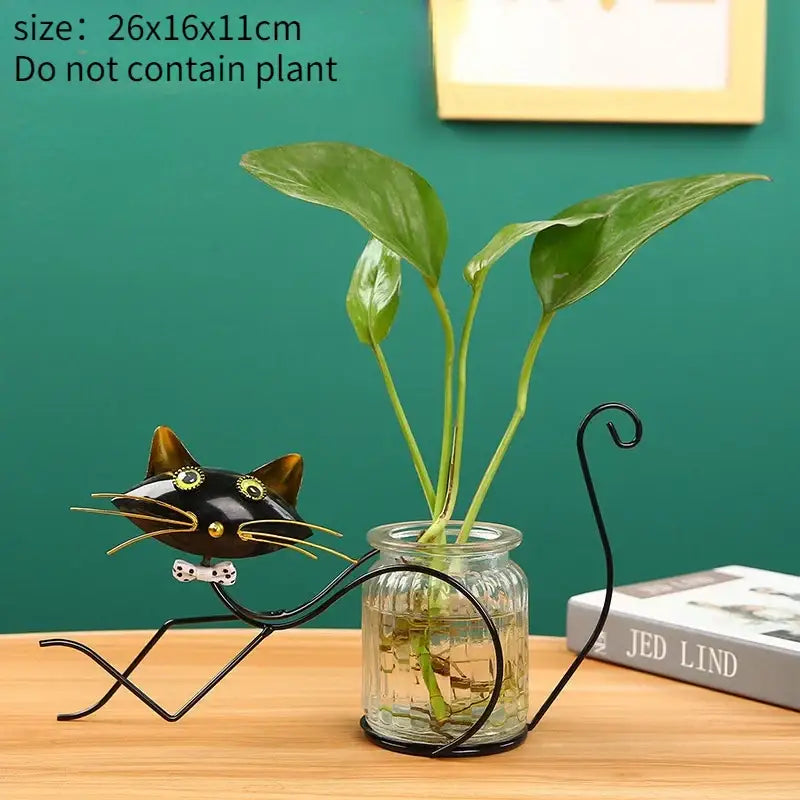 Decorbites™ flamingo metal vase black metal cat-shaped plant stand with gold accents holding glass jar with green leaves