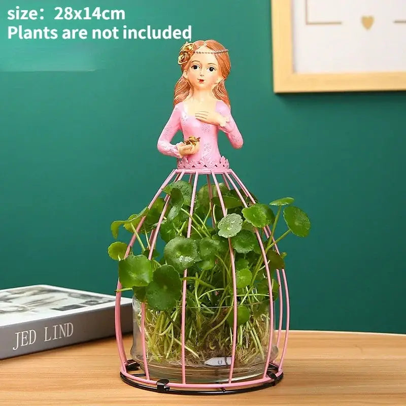 DecorBites™ flamingo metal vase with pink resin fairy figurine and green plants for elegant home decor display