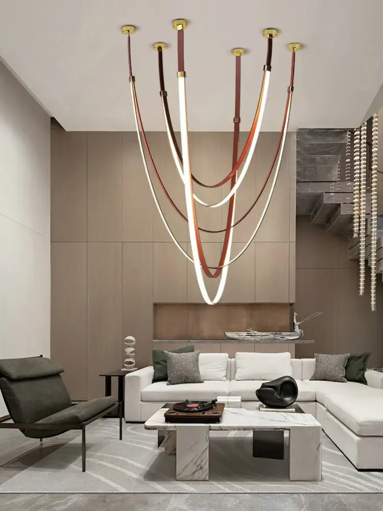 DecorBites™ flexible leather belt LED chandelier with white and brown leather strips and gold fixtures for living room