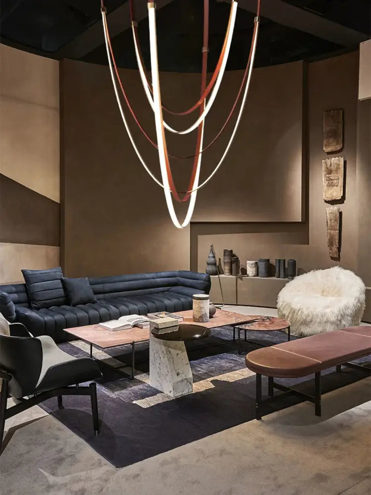 A modern sculptural chandelier featuring intertwined white and brown flexible leather belt bands for living room lighting