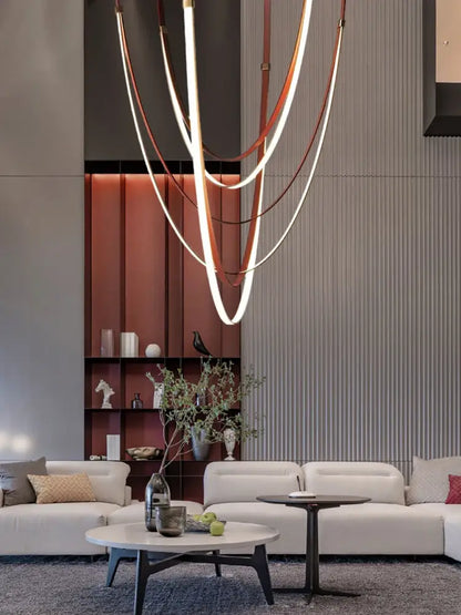 Modern sculptural chandelier featuring intertwined copper and white led light strips with flexible leather belt design