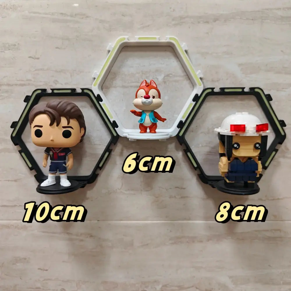 A white hexagonal decorbites™ floating display shelf holding a red and orange chip figurine for collectibles