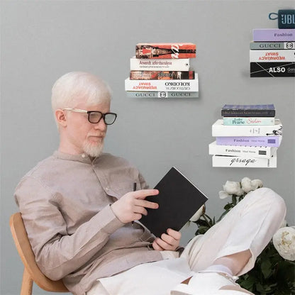A man in beige attire reads a book seated near DecorBites™ floating metal bookshelves 2pcs floating bookshelf set