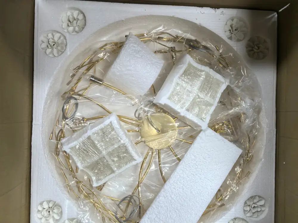 Gold-toned metal chandelier with clear glass panels and floral accents in decorbites™ french white flower chandelier design