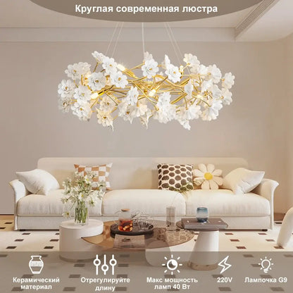 A modern DecorBites™ floral french white ceramic chandelier with delicate white flower chandelier on gold frame
