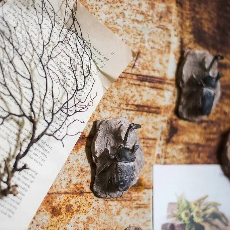 Dark textured beetle figurines on stone-like bases from decorbites fossil series art refrigerator stickers kitchen decor