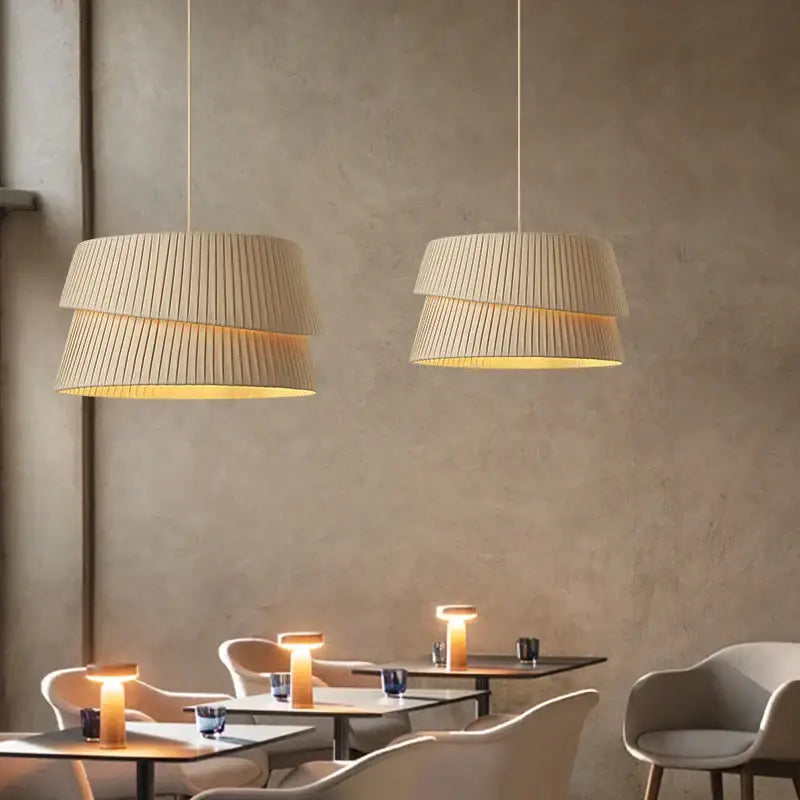 Beige pleated tiered pendant lights with warm glowing interiors in decorbites french cream chandelier fabric lamps