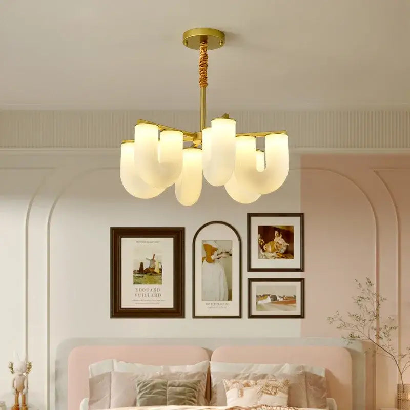 Gold-toned modern chandelier with frosted glass shades complementing decorbites french cream floor lamp design