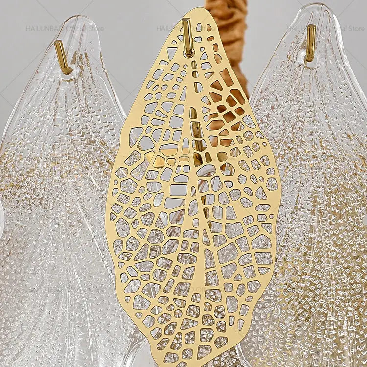 Gold-toned leaf-shaped decorative hook with intricate cutout pattern for decorbites french crystal chandelier use