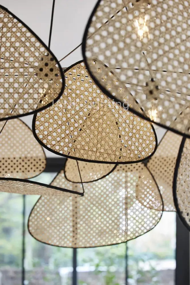 Beige woven rattan chandelier with black-framed butterfly shapes for home lighting in french design market
