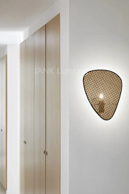 A modern wall-mounted rattan chandelier in warm golden-brown hue showcasing french design for home lighting