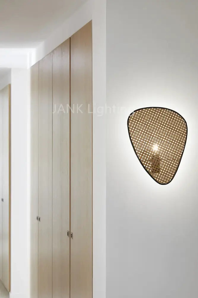 A modern wall-mounted rattan chandelier in warm golden-brown hue showcasing french design for home lighting