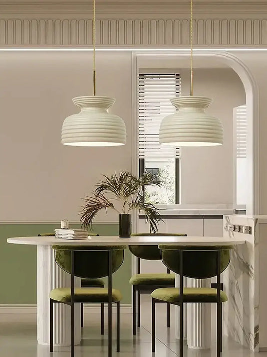 Two elegant off-white ribbed dome pendant lights with gold cords in a decorbites french minimalist chandelier design