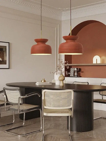 Two terracotta ribbed pendant lights showcasing decorbites french minimalist chandelier design above dining table